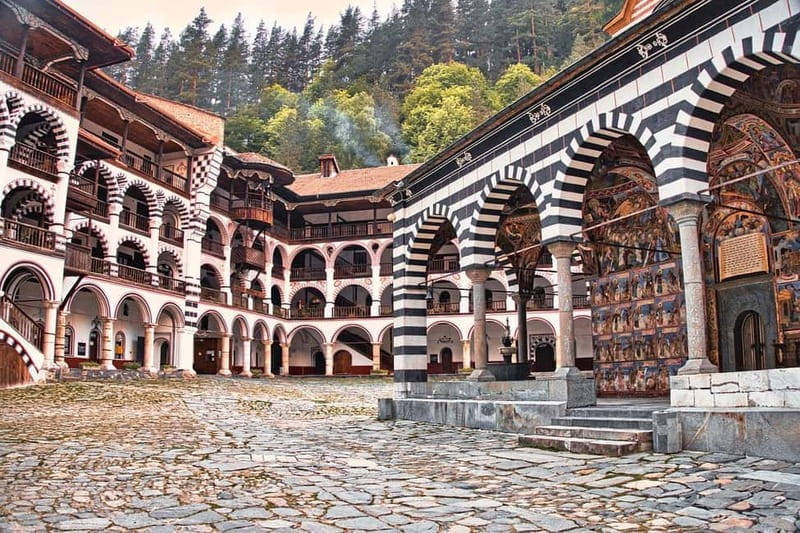The striped arcades of Rila Monastery under the Rila peaks